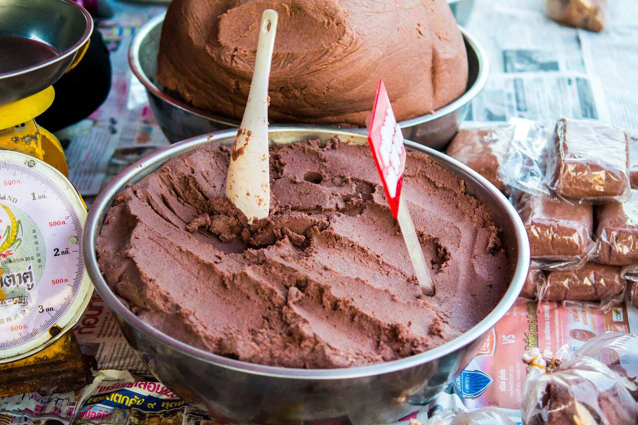 A bowl of fermented shrimp paste (belachan) that is ready for purchase at a shop. 