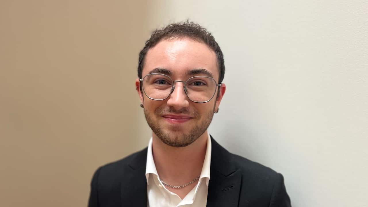 a young man with round glasses, close up shot