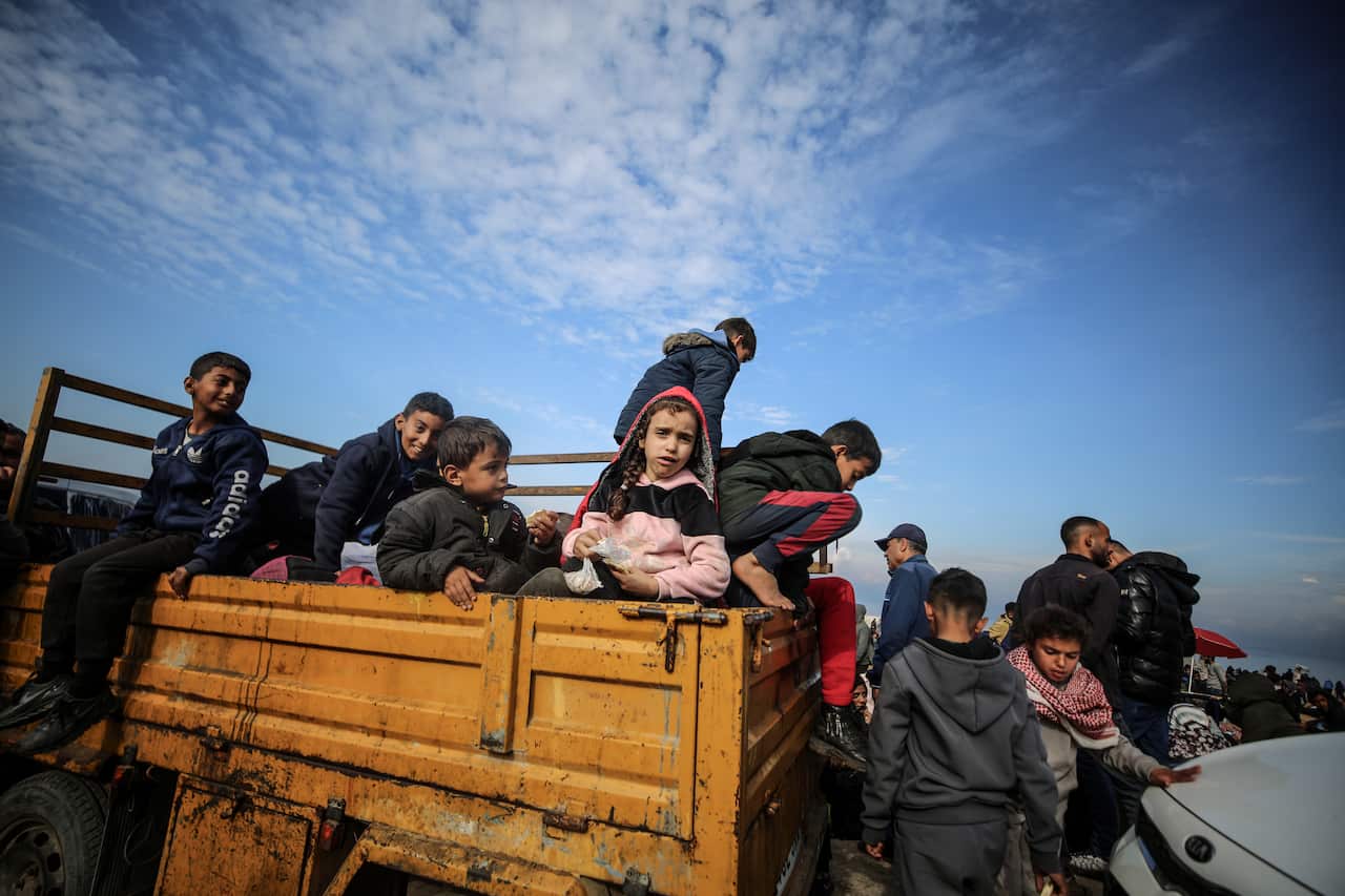 Palestinian children aboard a truck waiting to make the journey to the north of Gaza