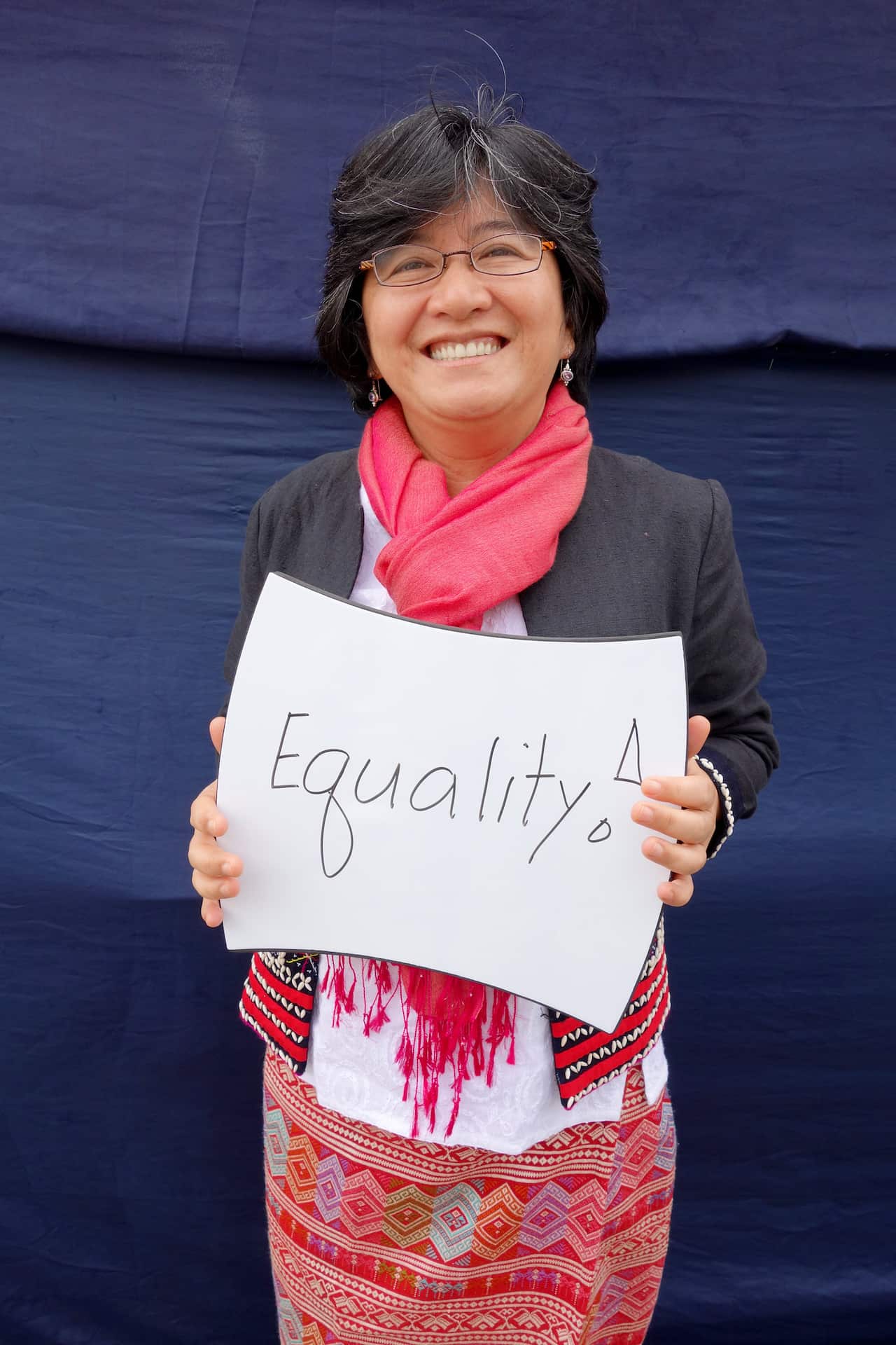 Woman holding a sign that reads equality.