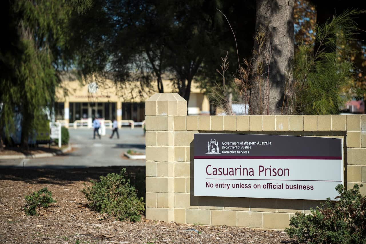 A sign out the front of a building reads: "Casuarina Prison: No entry unless on official business".