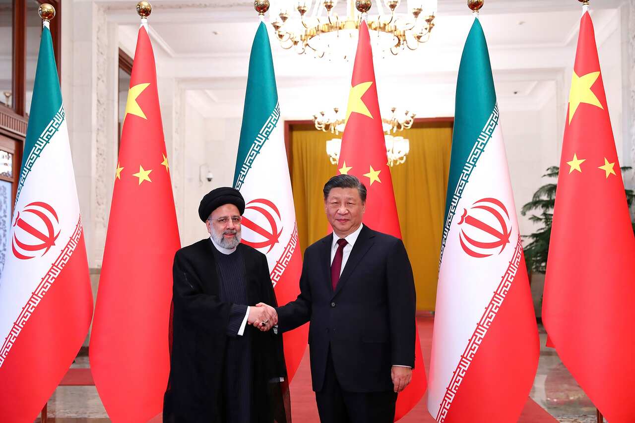 Iranian President Ebrahim Raisi (left) shakes hands with his Chinese counterpart Xi Jinping in an official welcoming ceremony in Beijing on 14 February 2023.