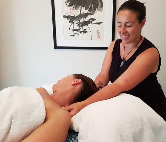 Monica giving a patient a remedial massage 