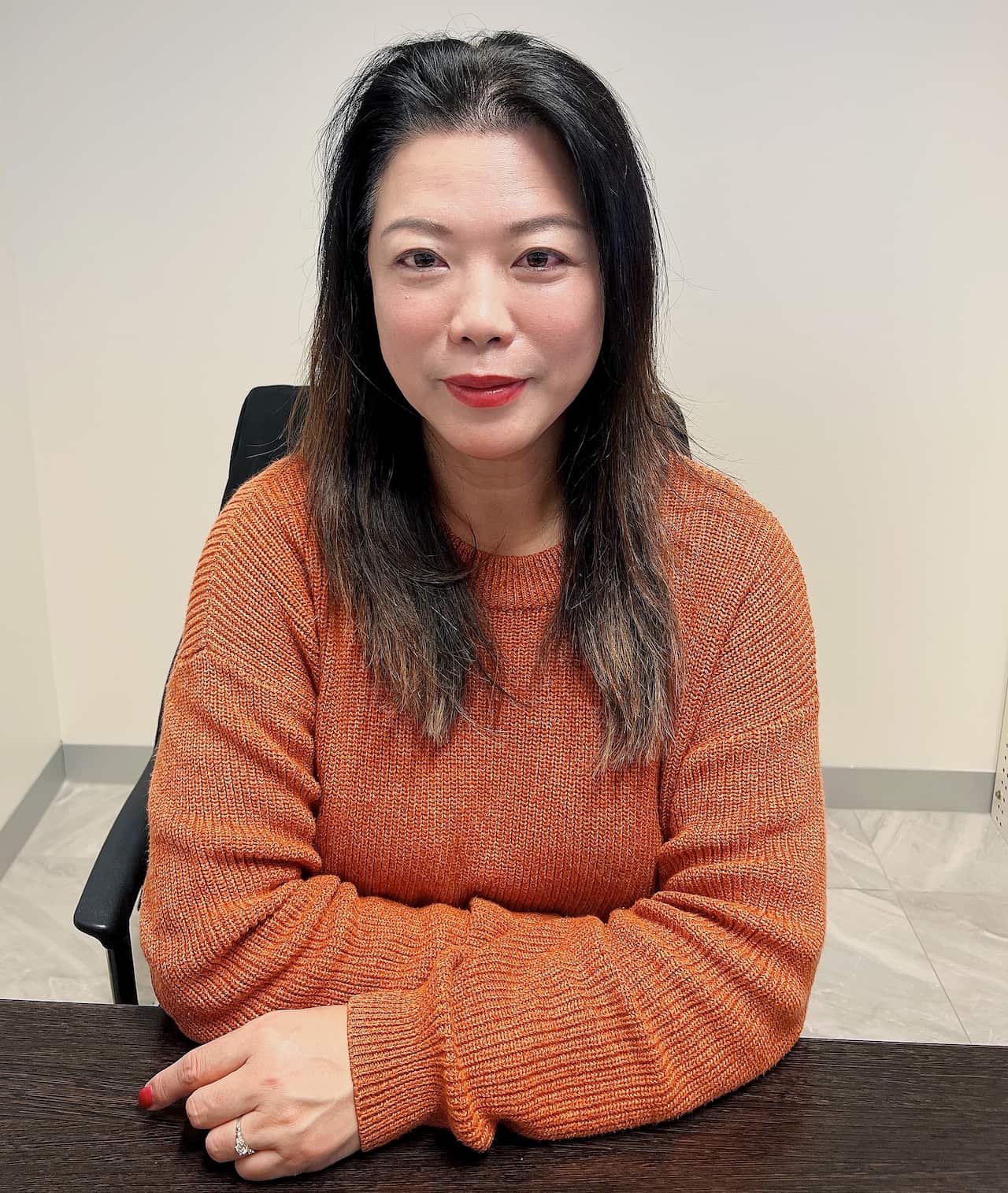 Faith Tan sitting at a desk