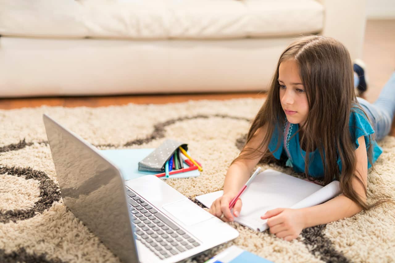 Girl attending online school classes from home