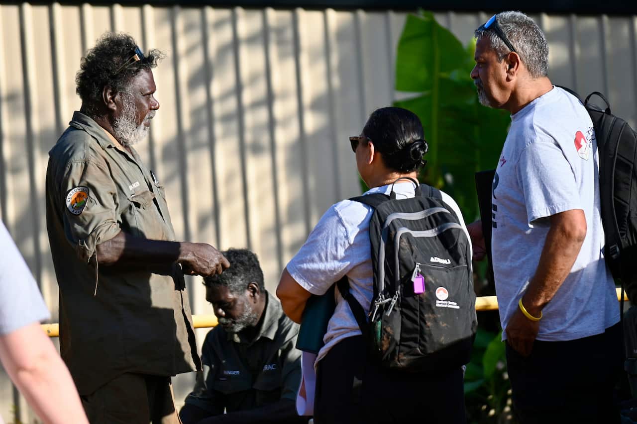The NT Electoral Commission engagement officers speak to local rangers about the upcoming election