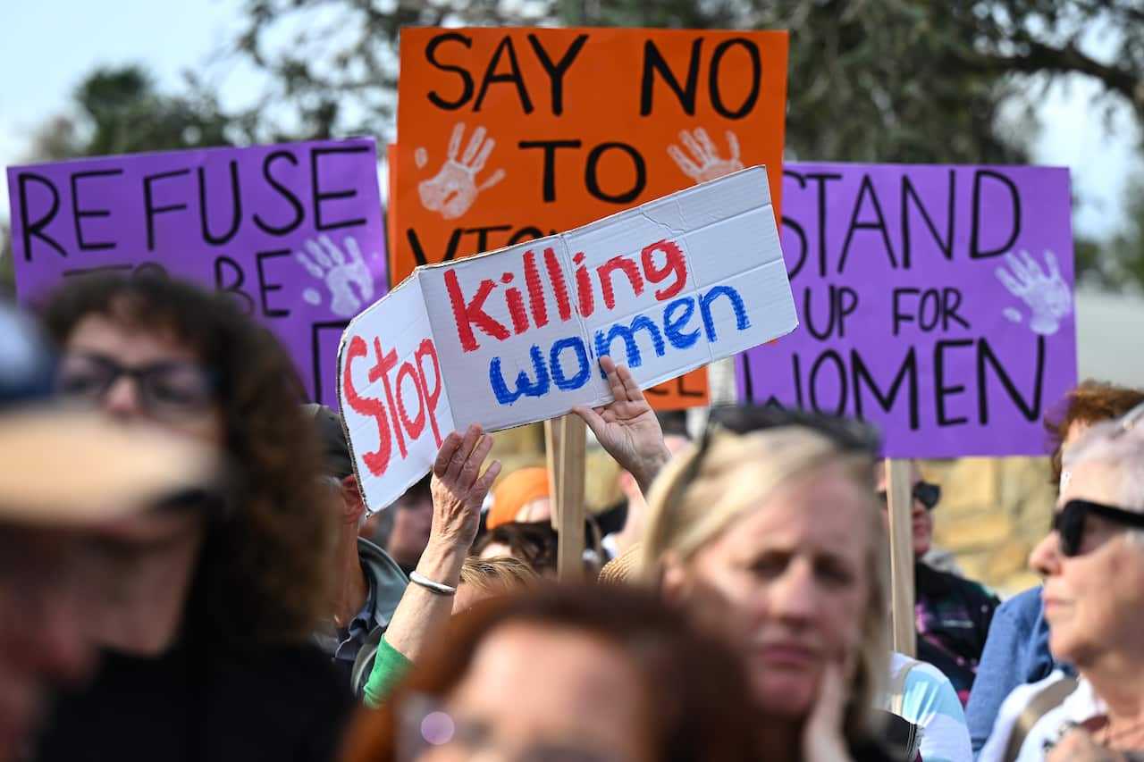 Protester holding sign that reads: "Stop Killing Women" at the National Rally against Violence in Canberra.