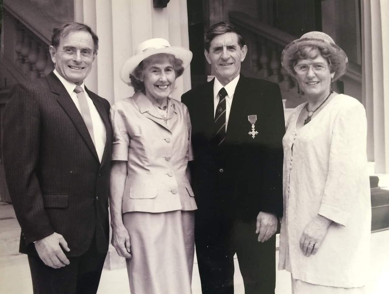 A black and white photo of two couples in formal wear. 