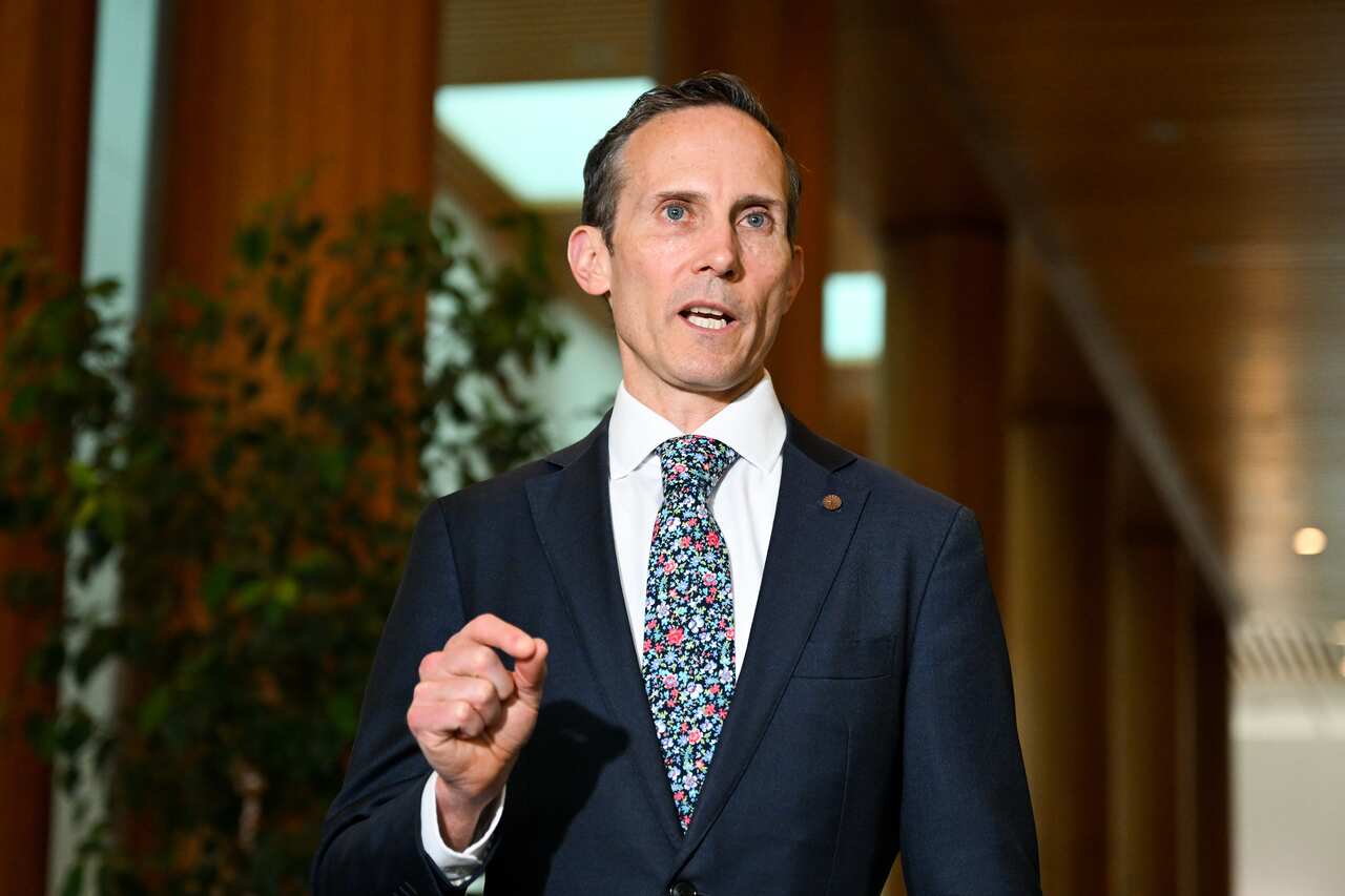 A man in a suit and tie speaks.