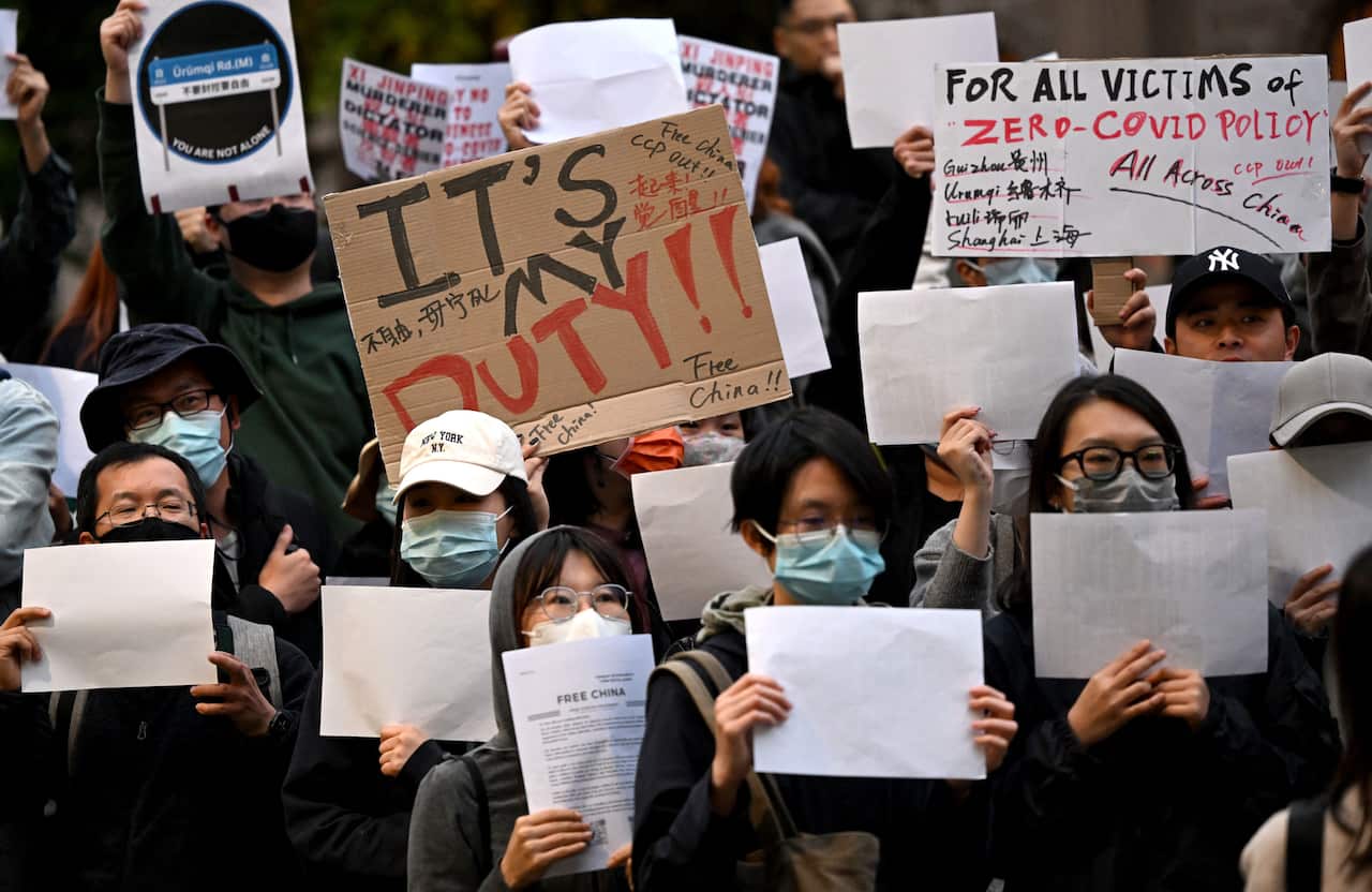 Protesters holding signs.