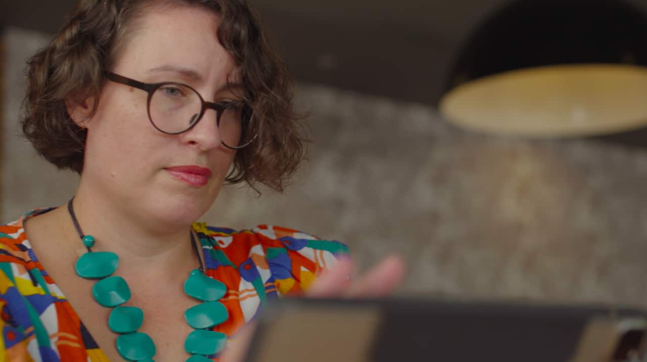 Dr Fiona Willer looks into her device. 