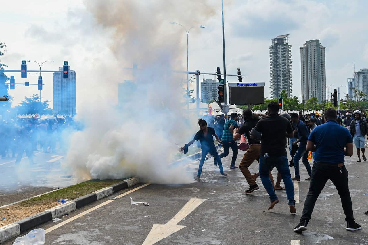 Tear gas coming out of canister in the middle of a crowd of protesters