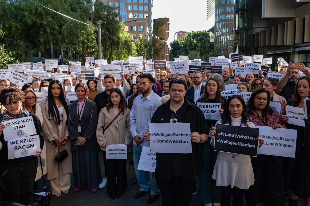 ABC staff holding placards in support of Stan Grant