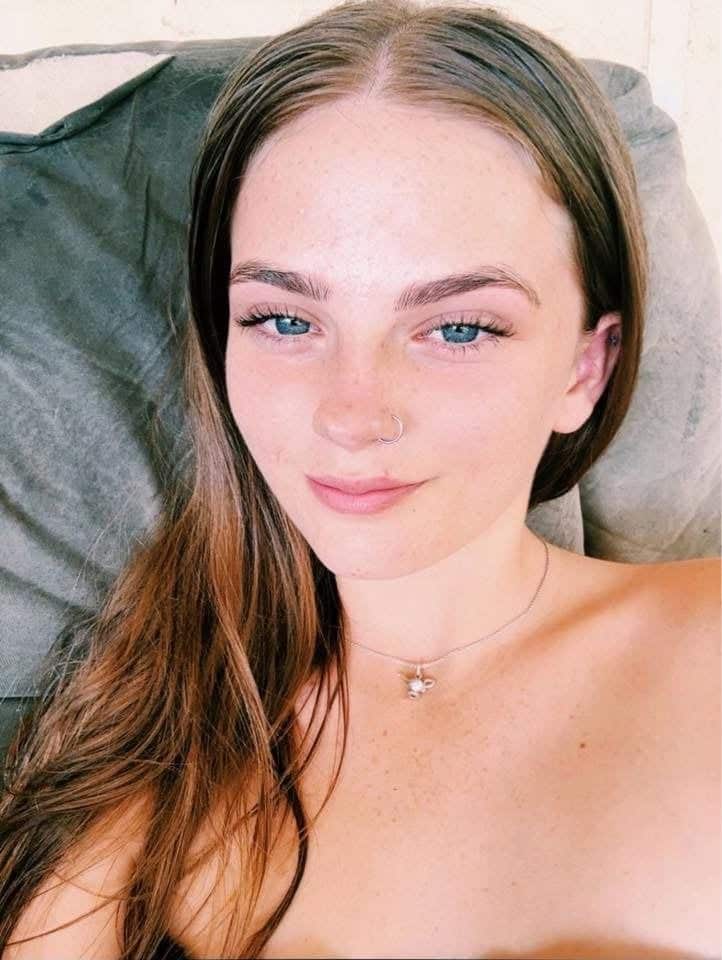 A selfie of a smiling teenage girl.