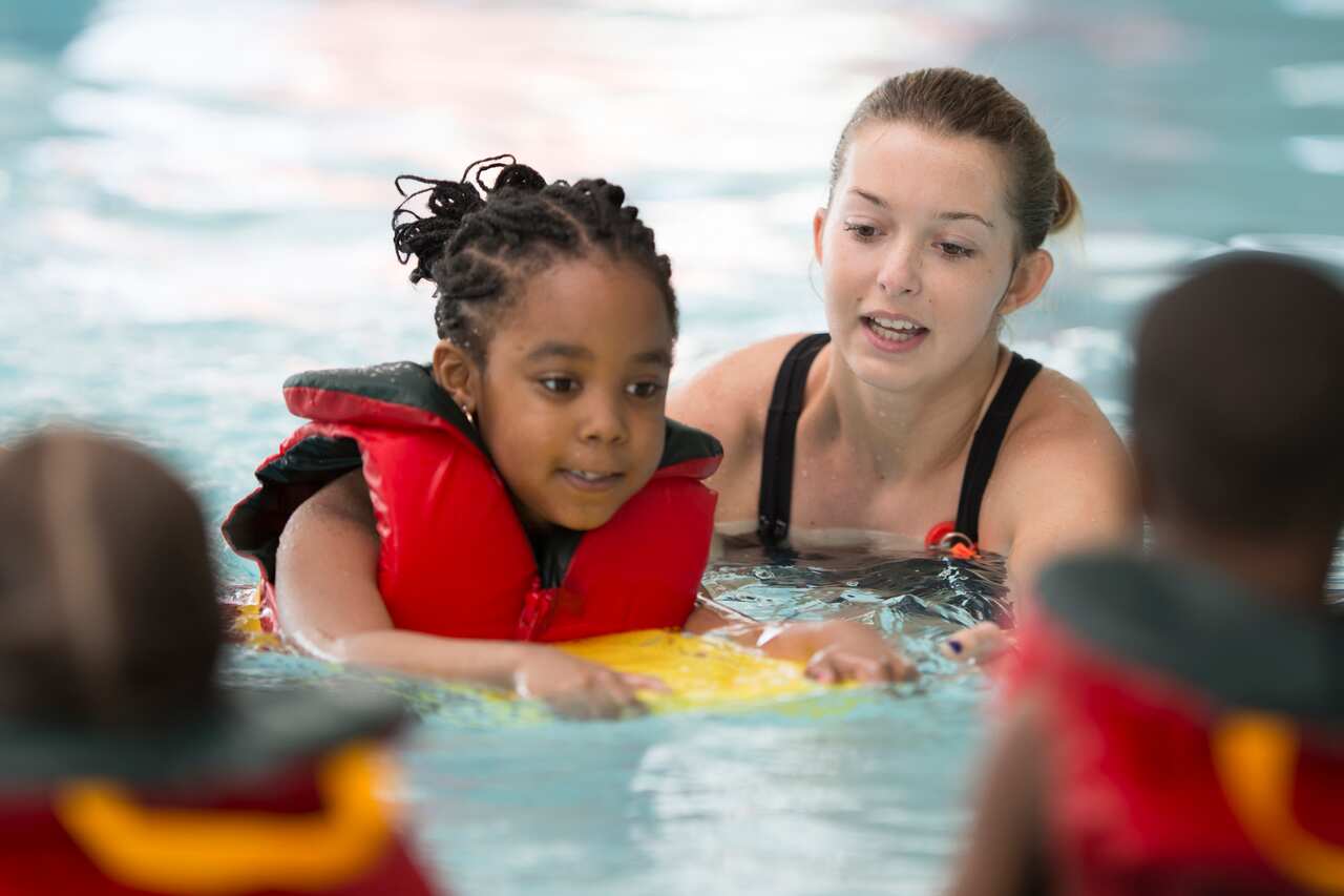 Swim Instructor Working with a Little Girl