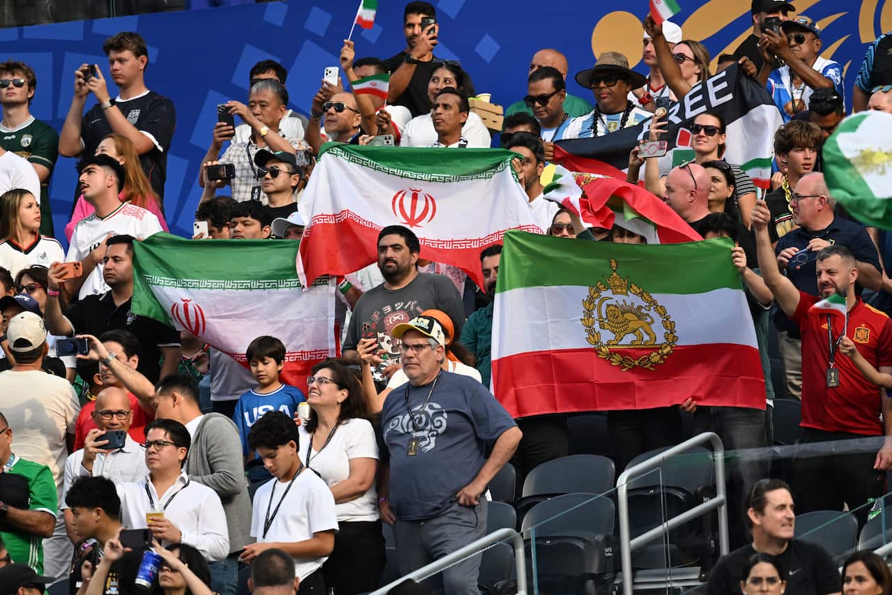 A woman protesting against the Iranian regime outside a football match