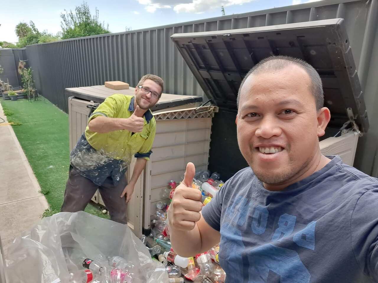 Archie Caadan with co-worker showcasing  their containers.JPG