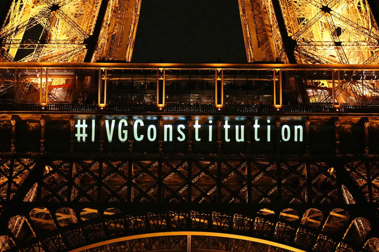 The phrase "#I VGConstitution" is shown projected onto the Eiffel Tower at night.