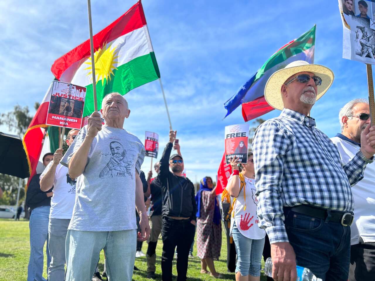 A group of people standing holding flags at a protest