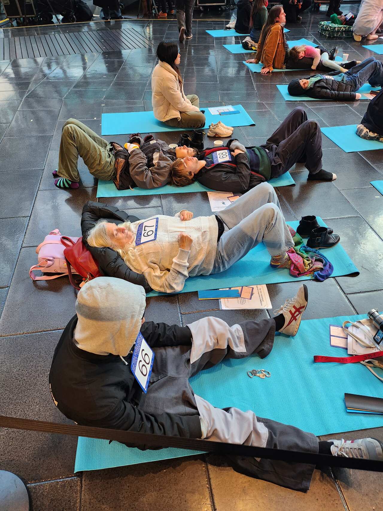 Several people lying on the floor in costumes.