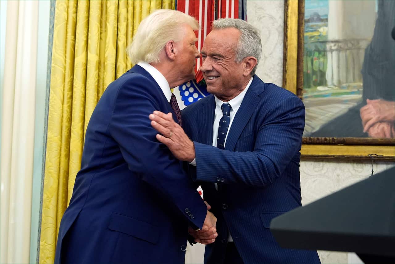 Donald Trump and Robert F Kennedy Jr shaking hands in the Oval Office.