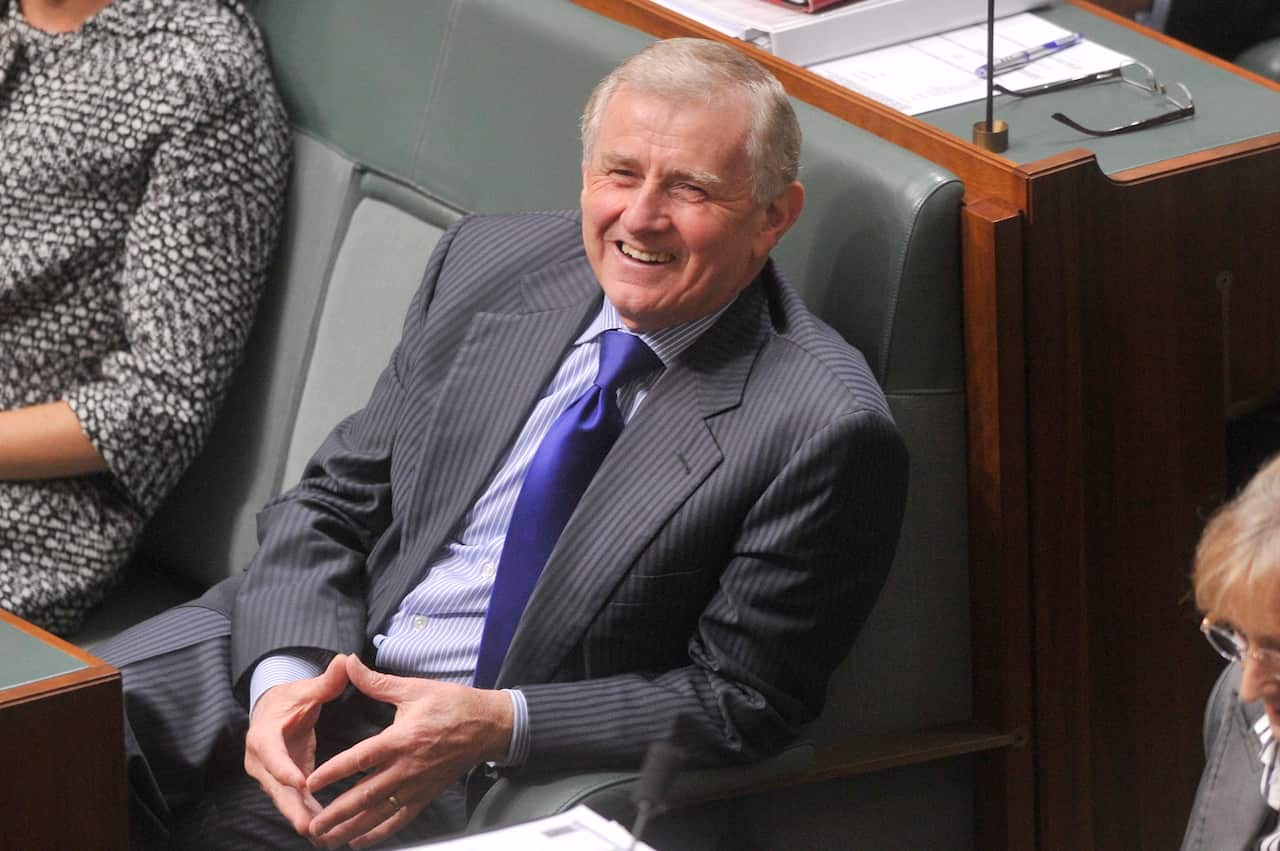 Simon Crean smiles during Question Time in federal parliament.
