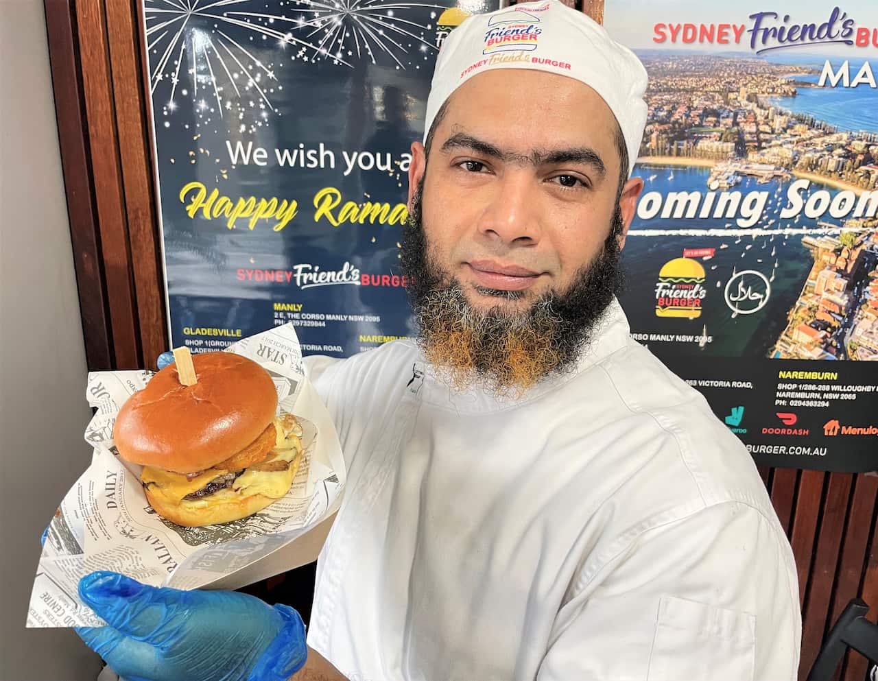 Masum Alam holds one of his signature burgers