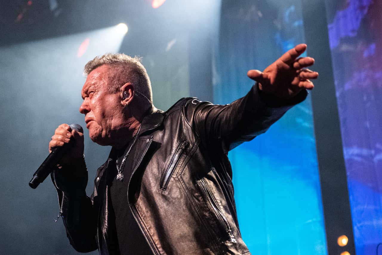 Jimmy Barnes performing on stage.