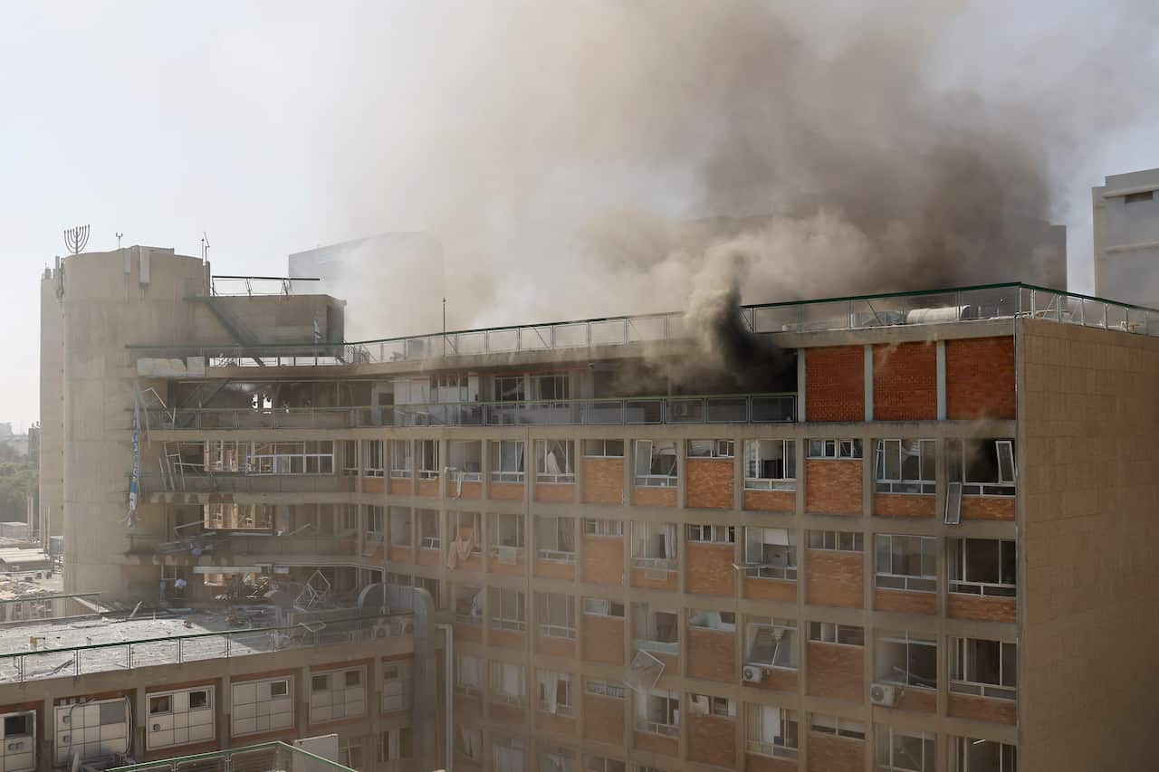 Smoke rising from a hospital that has been damaged.