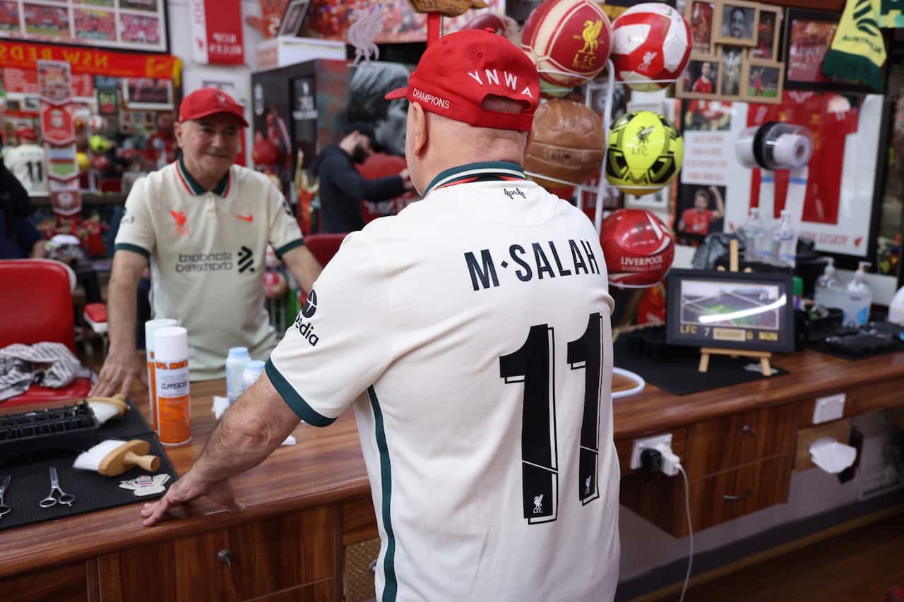 Reflecting on a massive match: Liverpool superfan Kleames Dawod is all smiles in his Sydney barber shop, proudly donning his ultimate hero Mohamed Salah before the Socceroos take on Egypt.
