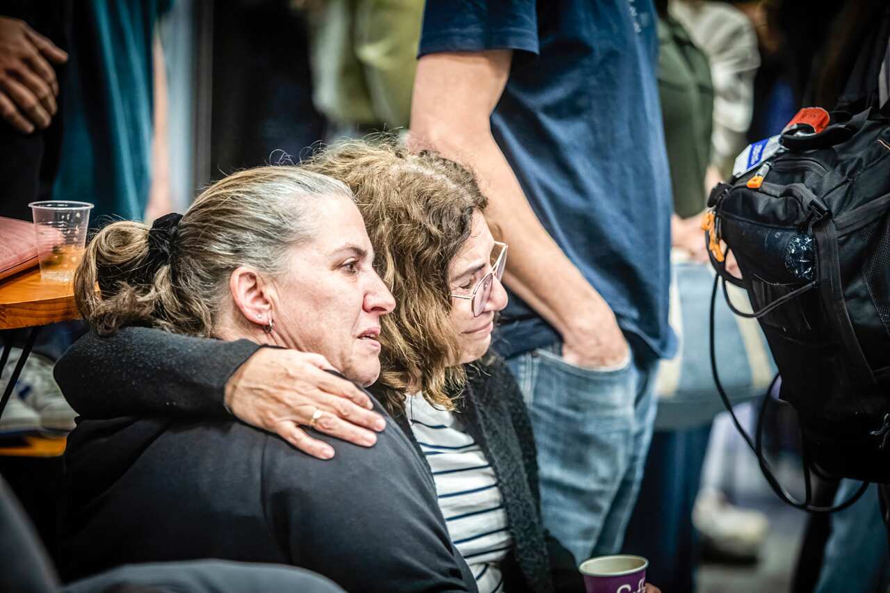 Two women hugging each other