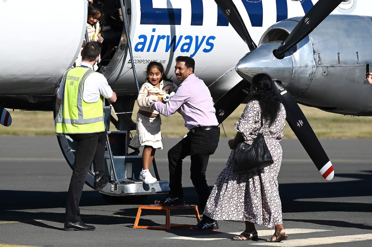 Family disembarking from plane