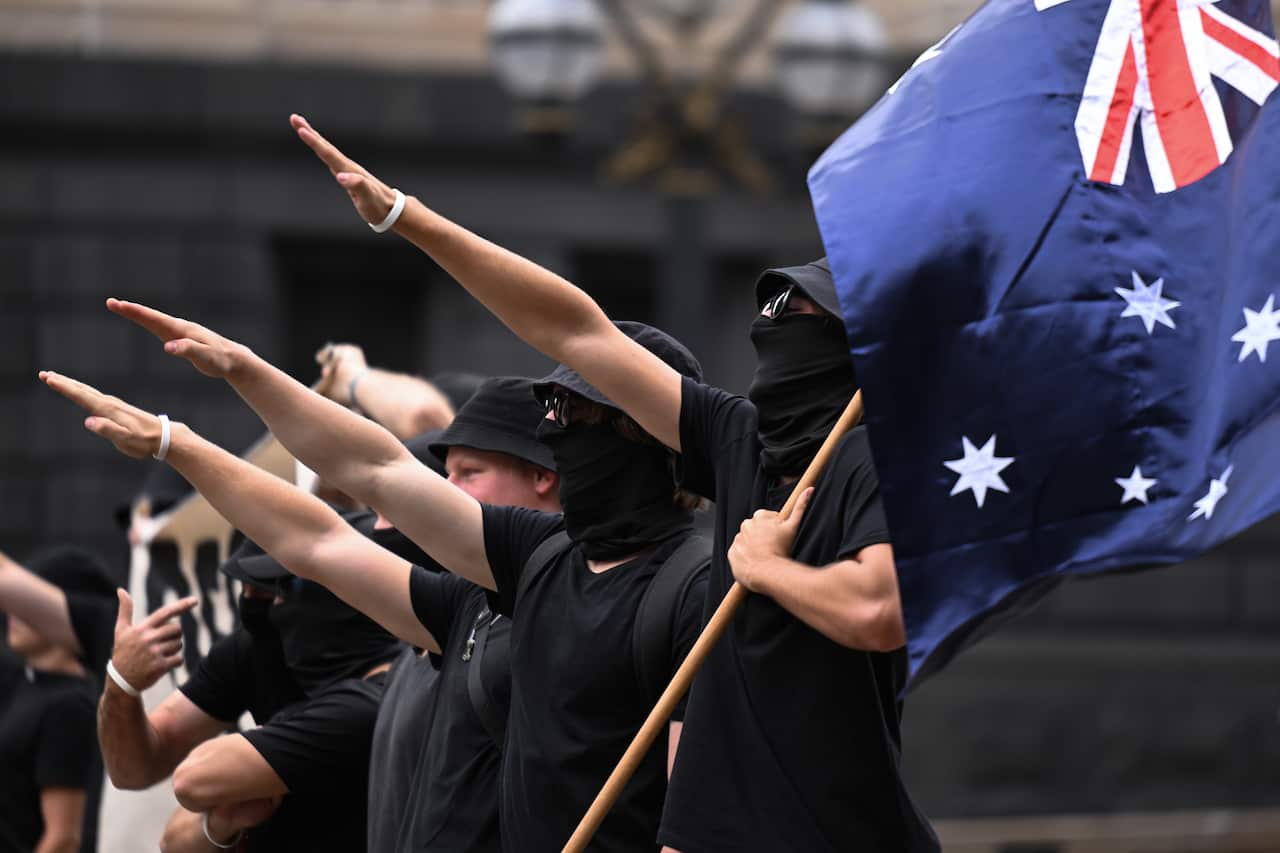 Neo-Nazis perform the Nazi salute at a protest in Melbourne. 