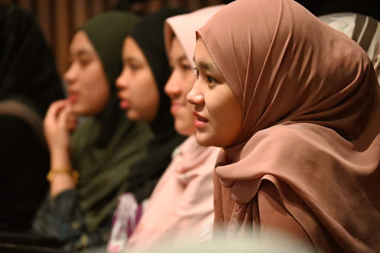 Side view of four girls wearing hijabs.