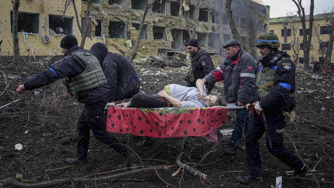 An injured pregnant woman is carried from a maternity hospital that was damaged by shelling in Mariupol, Ukraine (AAP).jpg