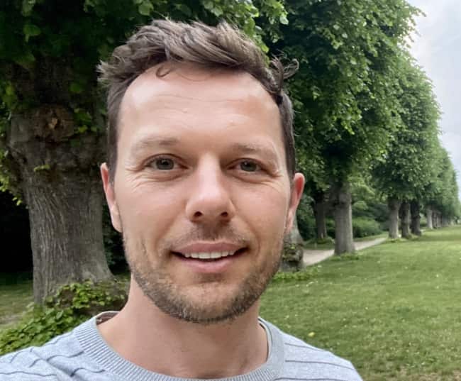 A selfie of a man outside in a park.