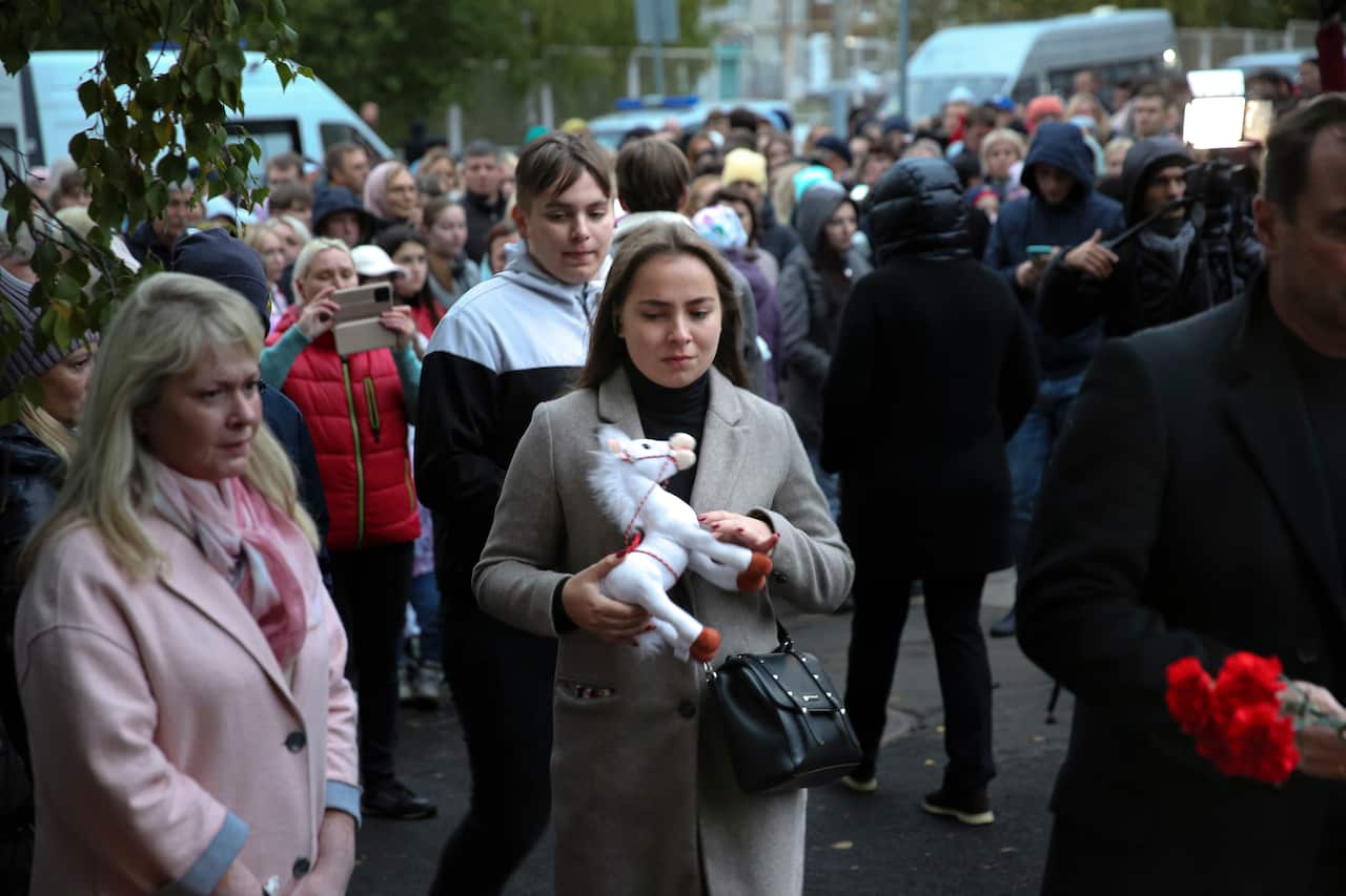 A woman holds a toy horse