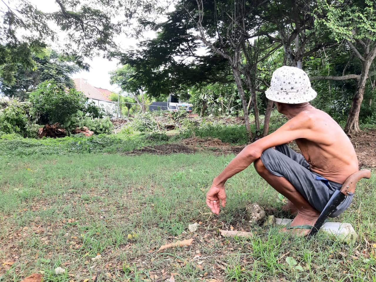 Land owner watching his neighbourinf farm bering cleared for development of multi story building.