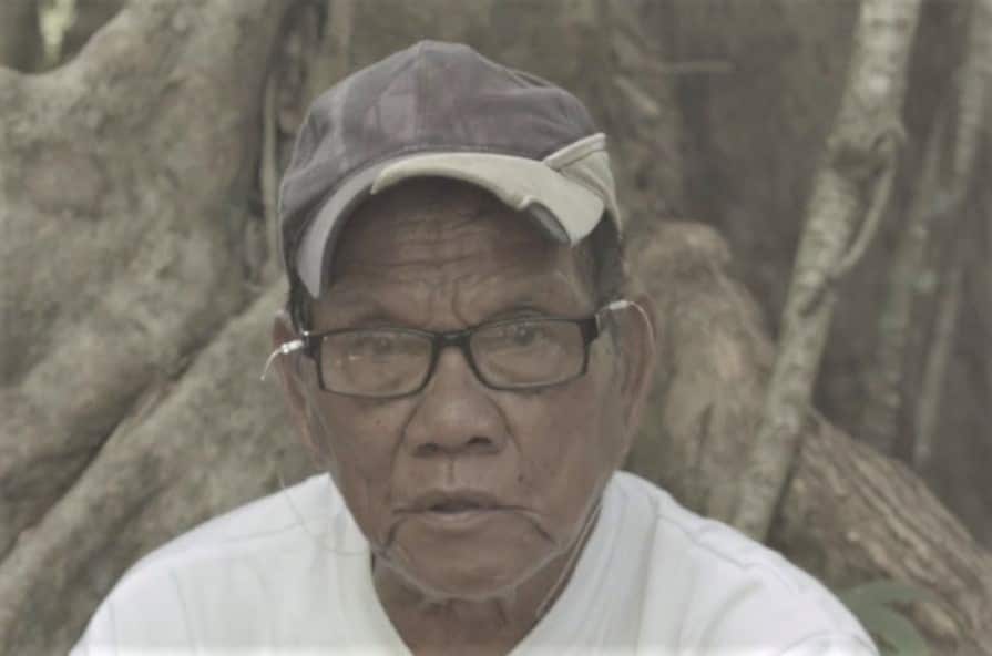 A man wearing a cap and glasses