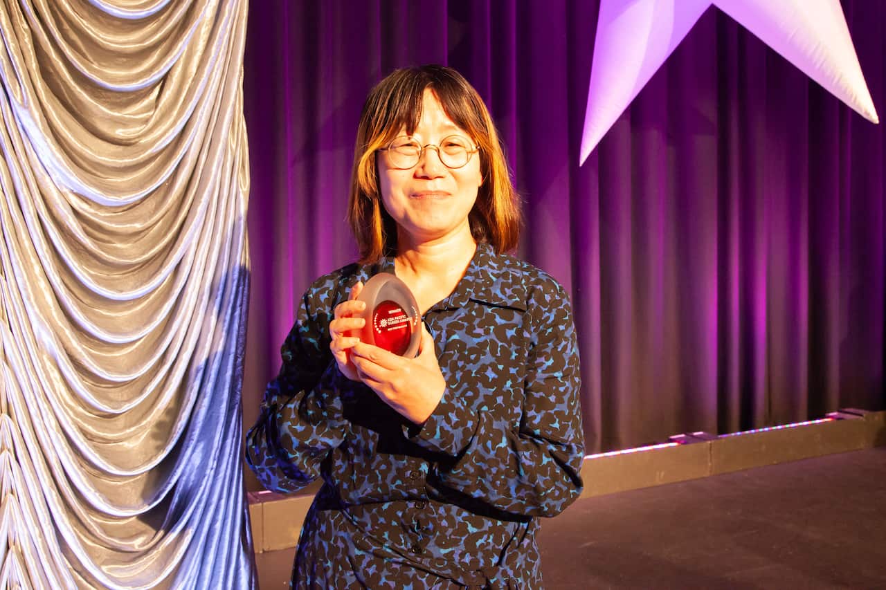 Shin Su-won accepts Best Performance on behalf of Lee Jeong-eun for Hommage photo by Jacqueline Bawtree 2 (1).jpeg