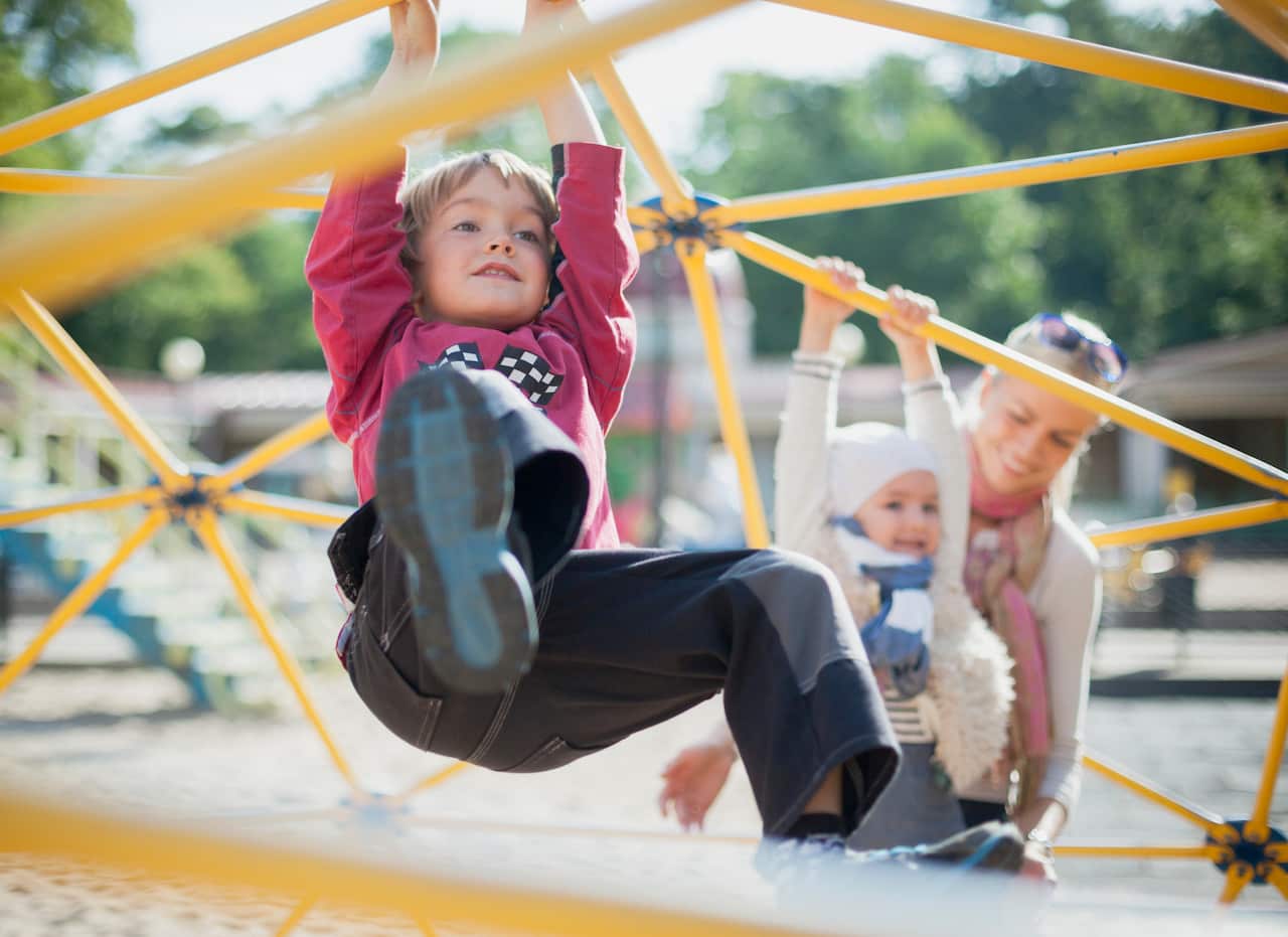 mother with 2 children on playground