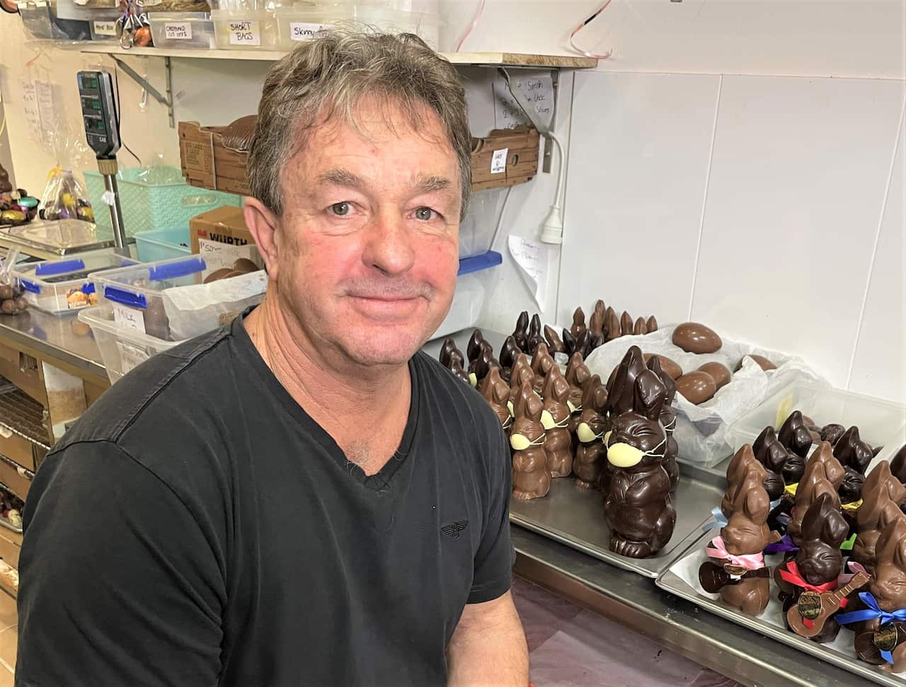 Paul Adam in front chocolate rabbits placed on a counter