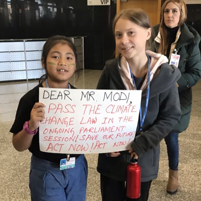 Indian climate activist Licypriya Kangujam and Swedish activist Greta Thunberg hold a sign directed at Indian prime minister Narendra Modi.