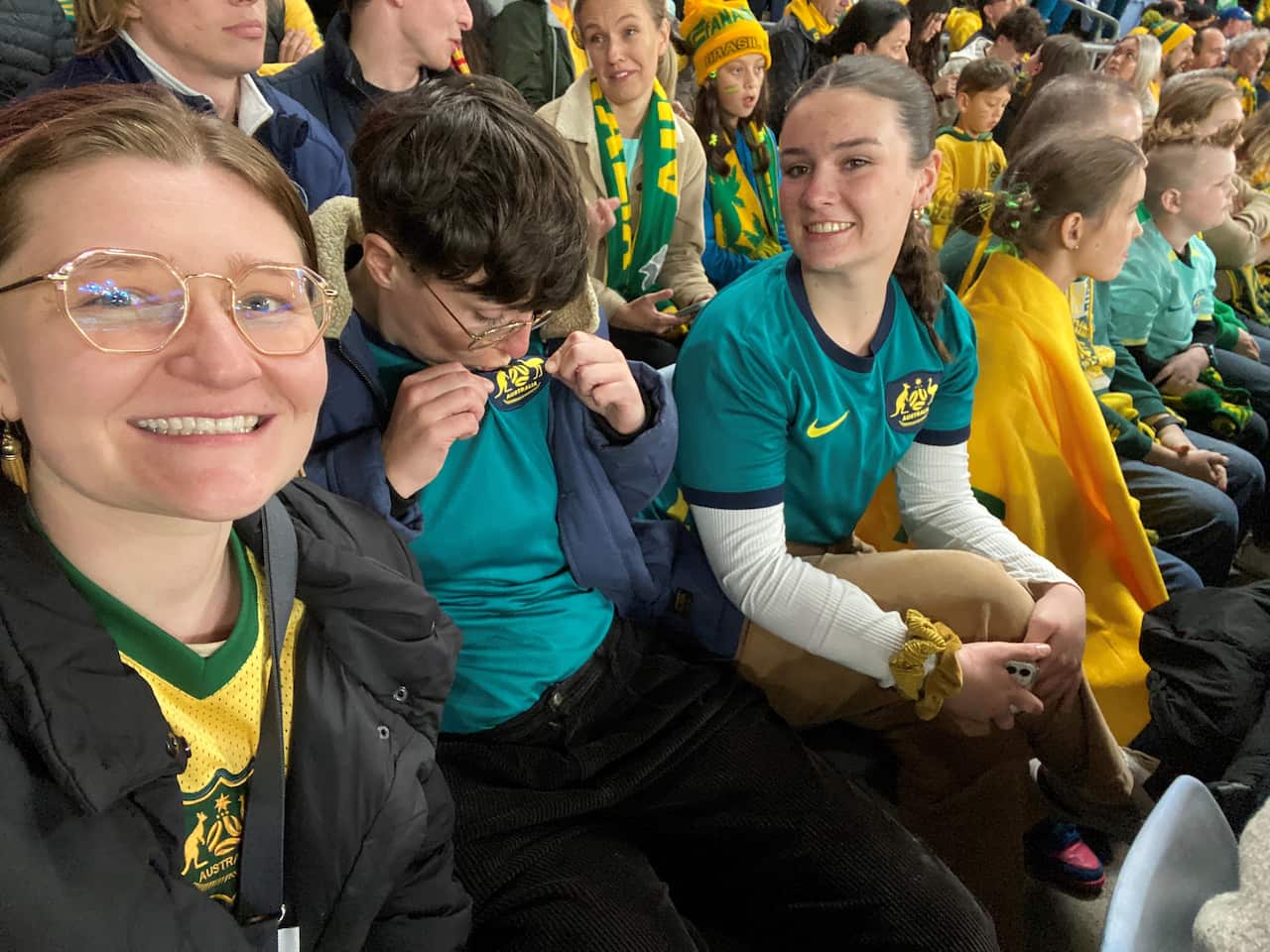 Three women sitting in a line.