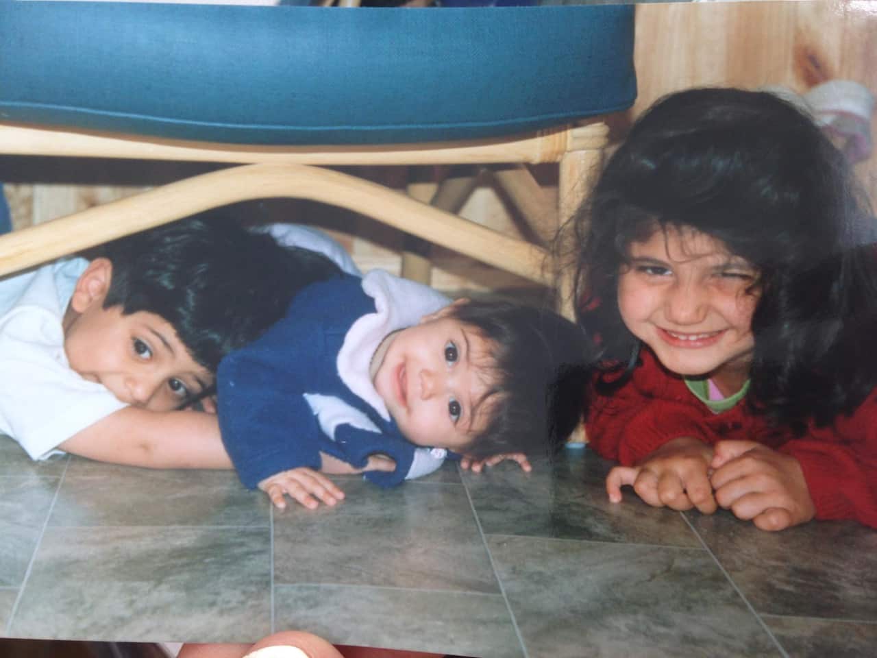 Ayesha Madon on the floor as a baby surrounded by her older sister and brother