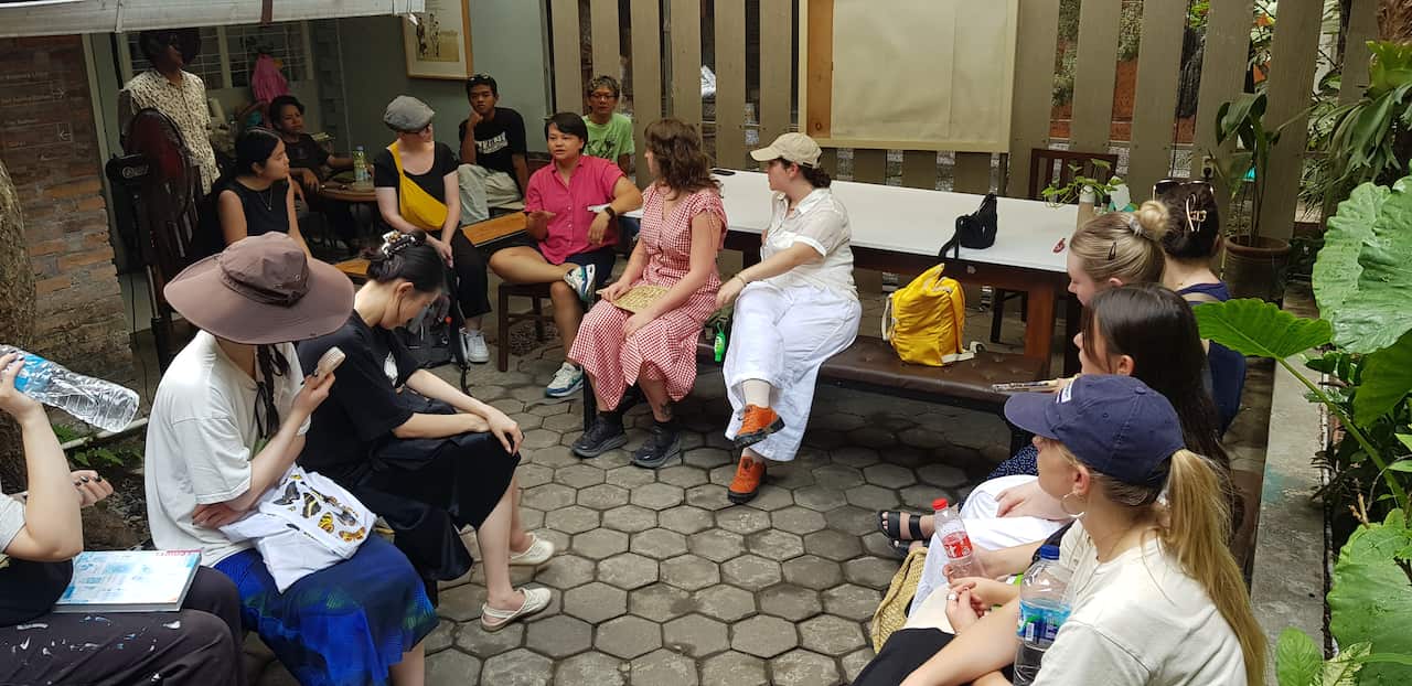  Sukma Smita (in red shirt) from KRACK! Collective talking to visiting Monash University students to the KRACK! Studio -  2022. Photo by Dr Michelle Antoinette.