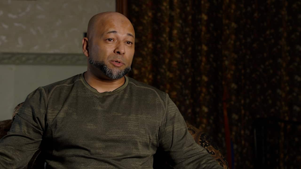 A man sitting for an interview.