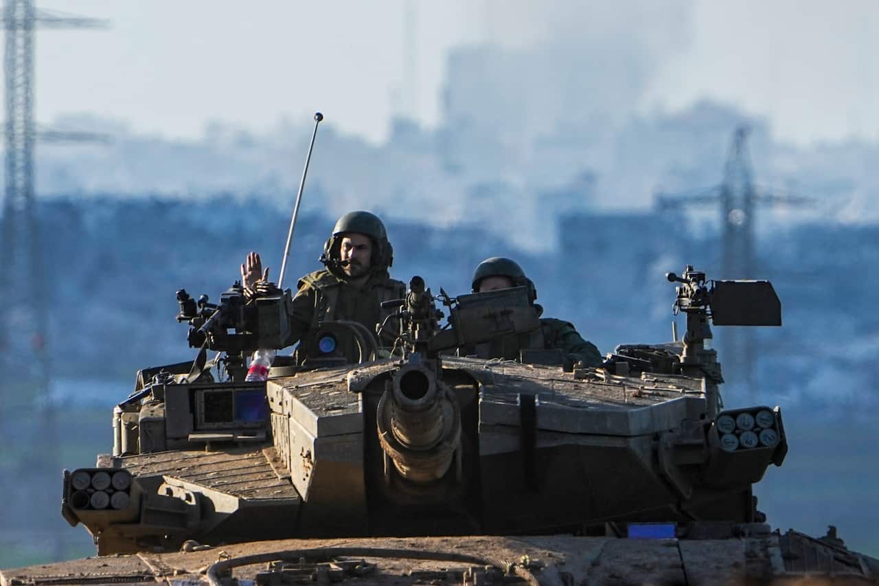 Israeli soldiers drive a tank on the border with the Gaza Strip, as seen from southern Israel.