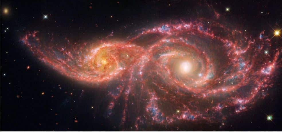 Two spiral rows of lights, orange on the left and reddish on the right, graze each other, with both featuring yellow centres.