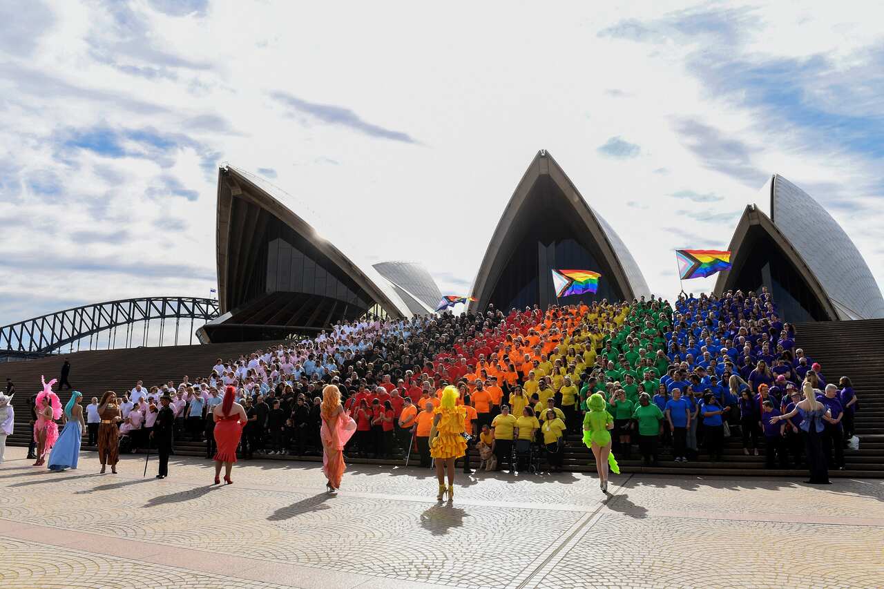 People dressed in different rainbow colours